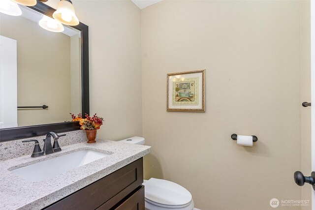 bathroom featuring vanity and toilet