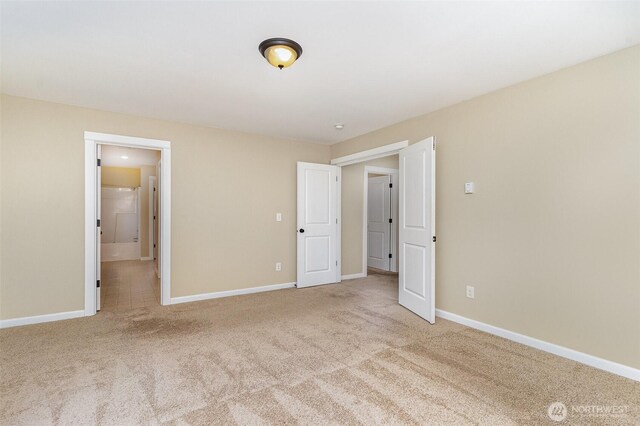 unfurnished bedroom with carpet floors and baseboards