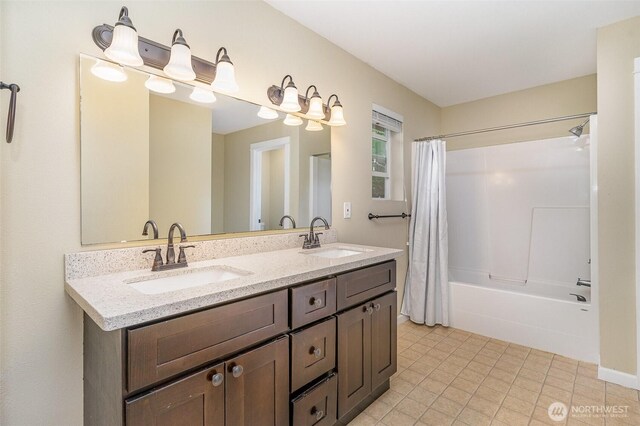 bathroom with a sink, tile patterned flooring, double vanity, and shower / tub combo with curtain