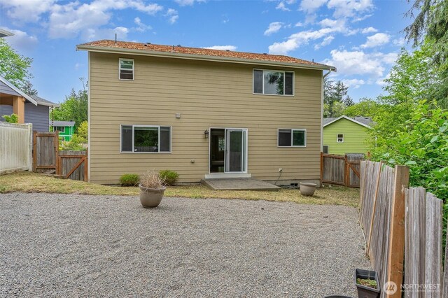 rear view of house featuring a patio, a gate, and a fenced backyard