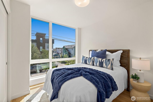 2414 NW 64th St Unit A, Seattle, WA 98107 - bedroom featuring wood finished floors and floor to ceiling windows