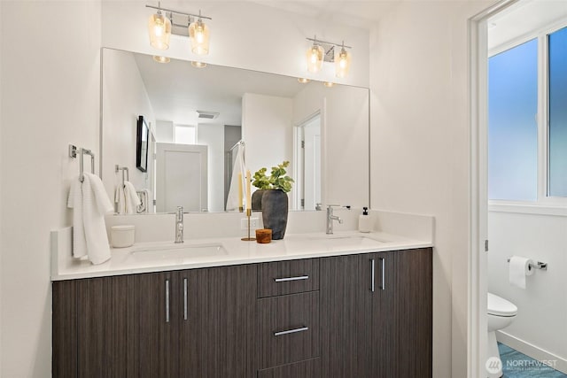 2414 NW 64th St Unit A, Seattle, WA 98107 - full bath featuring double vanity, toilet, and baseboards