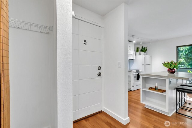 interior space featuring light wood-style floors and baseboards