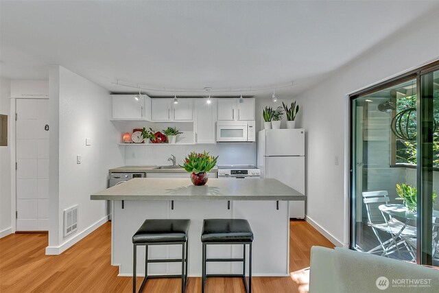 kitchen with visible vents, open shelves, light wood-type flooring, white cabinets, and white appliances