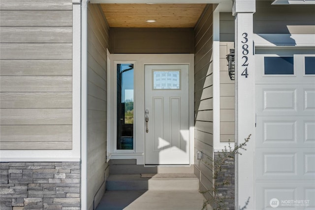 entrance to property featuring stone siding