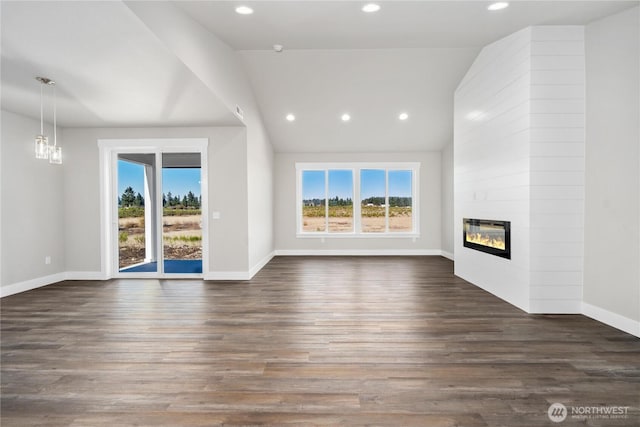 unfurnished living room featuring baseboards, a fireplace, recessed lighting, and a wealth of natural light
