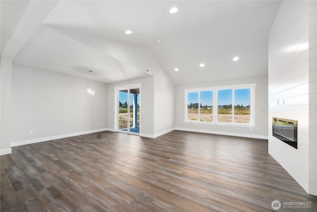 unfurnished living room featuring recessed lighting, baseboards, heating unit, and dark wood-type flooring