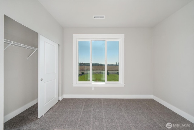 unfurnished bedroom with carpet floors, baseboards, and visible vents