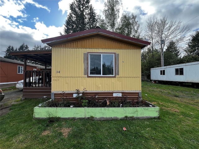 view of side of property with a yard