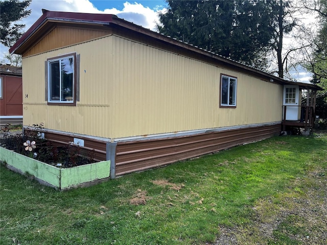 view of side of home with a lawn