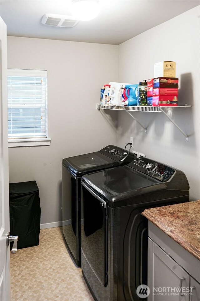 washroom featuring washer and dryer, baseboards, visible vents, and light floors