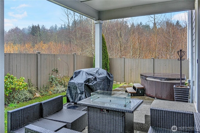 view of patio / terrace featuring a fenced backyard, outdoor lounge area, a hot tub, and area for grilling