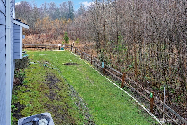 view of yard featuring central air condition unit and fence