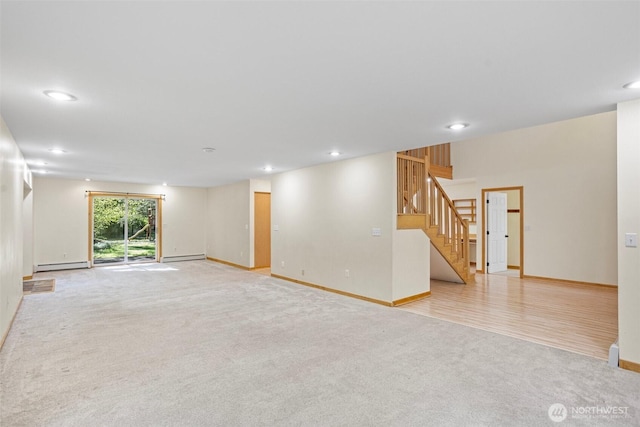 15845 118th Ln SE, Yelm, WA 98597 - unfurnished room with light colored carpet, baseboard heating, stairs, recessed lighting, and baseboards
