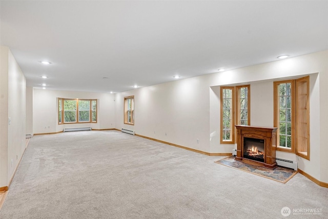 15845 118th Ln SE, Yelm, WA 98597 - unfurnished living room with baseboards, a baseboard radiator, recessed lighting, and light colored carpet