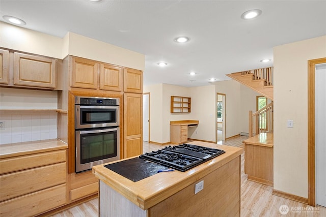 15845 118th Ln SE, Yelm, WA 98597 - kitchen with stainless steel double oven, black gas stovetop, light wood-style flooring, and light brown cabinets