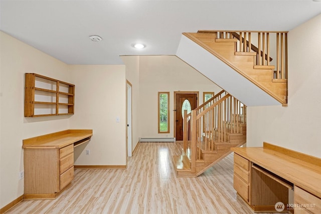 15845 118th Ln SE, Yelm, WA 98597 - foyer featuring stairs, light wood-style floors, baseboards, built in study area, and a baseboard radiator