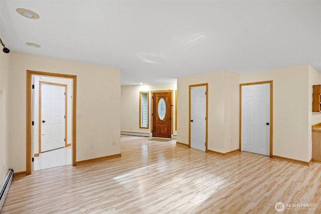 15845 118th Ln SE, Yelm, WA 98597 - foyer entrance featuring baseboards, baseboard heating, and light wood finished floors