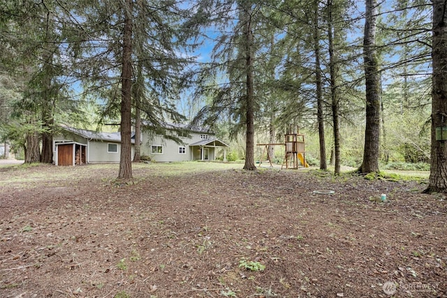15845 118th Ln SE, Yelm, WA 98597 - view of yard with a playground and a garage