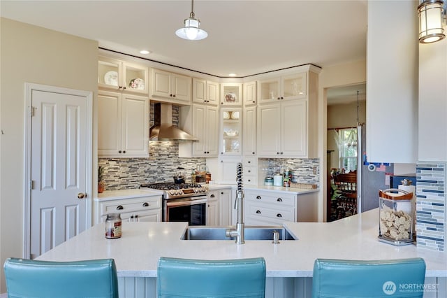 1664 Shine Rd, Port Ludlow, WA 98365 - kitchen with wall chimney exhaust hood, gas stove, a sink, pendant lighting, and tasteful backsplash