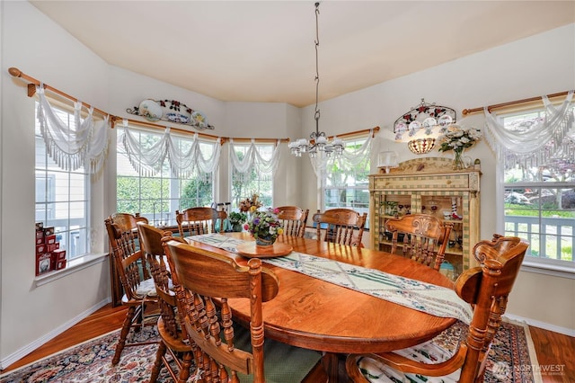 1664 Shine Rd, Port Ludlow, WA 98365 - dining space featuring a chandelier, wood finished floors, and baseboards