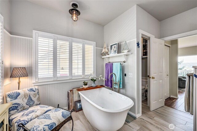 1664 Shine Rd, Port Ludlow, WA 98365 - bathroom with a soaking tub, wood finished floors, and toilet