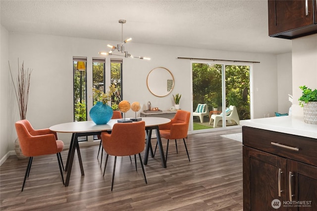 dining room with a notable chandelier, a textured ceiling, and dark wood-type flooring