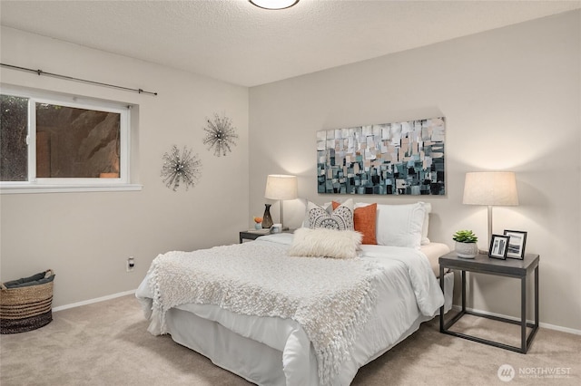 carpeted bedroom featuring baseboards and a textured ceiling