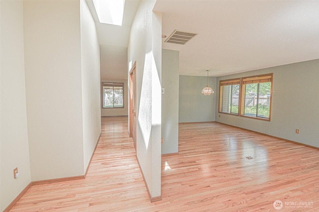 4310 Brookdale Rd E, Tacoma, WA 98446 - hallway with healthy amount of natural light, light wood-style floors, a skylight, and a chandelier