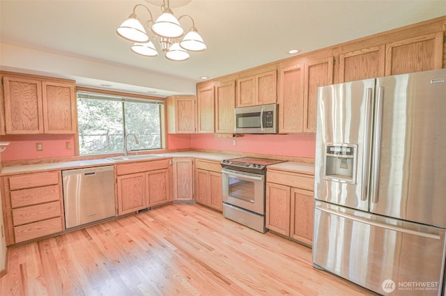 4310 Brookdale Rd E, Tacoma, WA 98446 - kitchen featuring appliances with stainless steel finishes, a sink, light brown cabinets, a chandelier, and light countertops