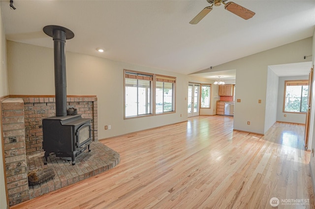 4310 Brookdale Rd E, Tacoma, WA 98446 - unfurnished living room featuring a wood stove, lofted ceiling, light wood-style flooring, a ceiling fan, and recessed lighting