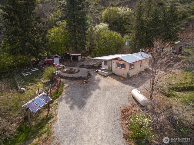 drone / aerial view featuring a forest view