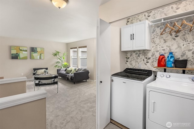 laundry area featuring cabinet space, separate washer and dryer, baseboards, and carpet floors