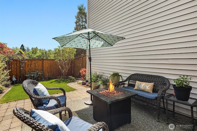 view of patio featuring fence and an outdoor living space with a fire pit