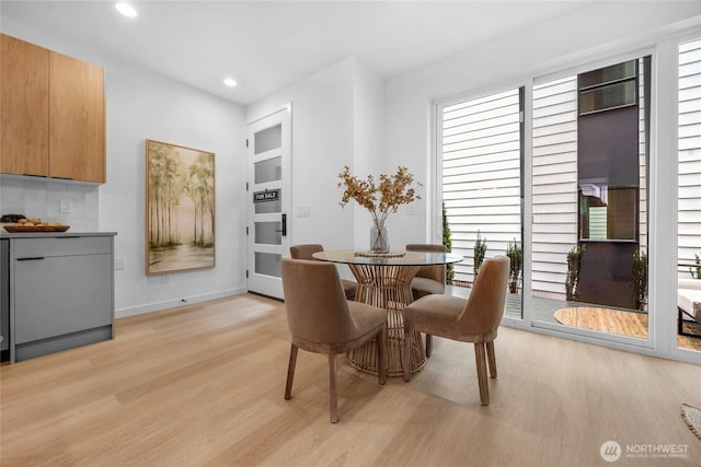 dining room with plenty of natural light and light wood-style flooring