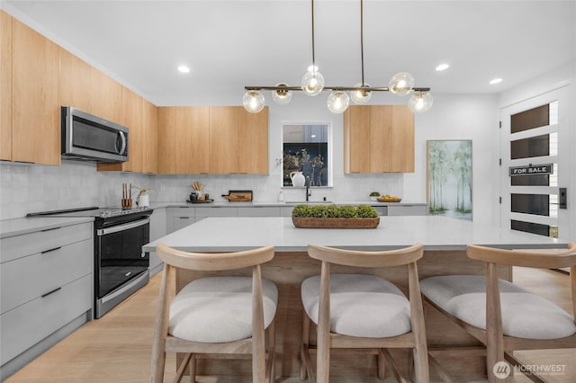kitchen featuring light countertops, appliances with stainless steel finishes, and modern cabinets