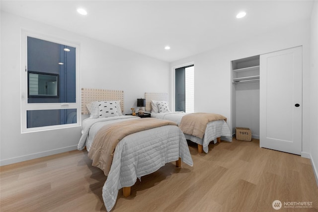 bedroom featuring recessed lighting, baseboards, a closet, and light wood-type flooring