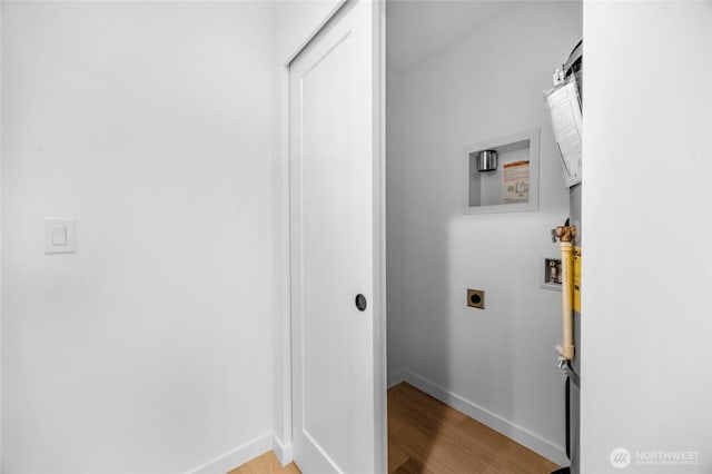 laundry area with laundry area, washer hookup, baseboards, light wood-type flooring, and hookup for an electric dryer