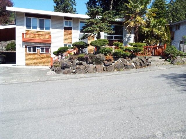 view of front of property featuring a carport and concrete driveway