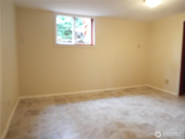 empty room with baseboards and carpet floors