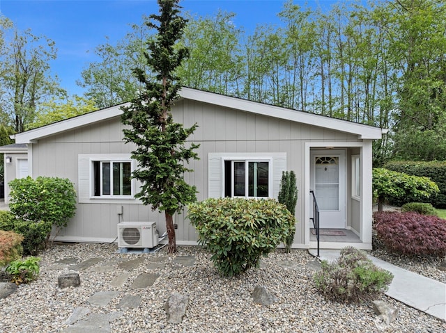 single story home featuring ac unit