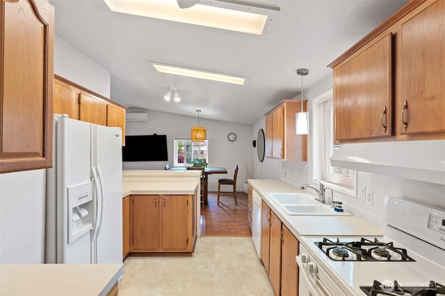 kitchen with a peninsula, white appliances, ventilation hood, vaulted ceiling with skylight, and a sink