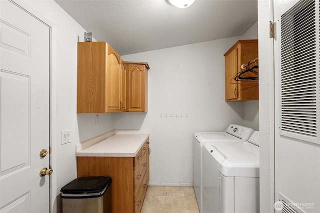 laundry area with separate washer and dryer, baseboards, cabinet space, and a heating unit