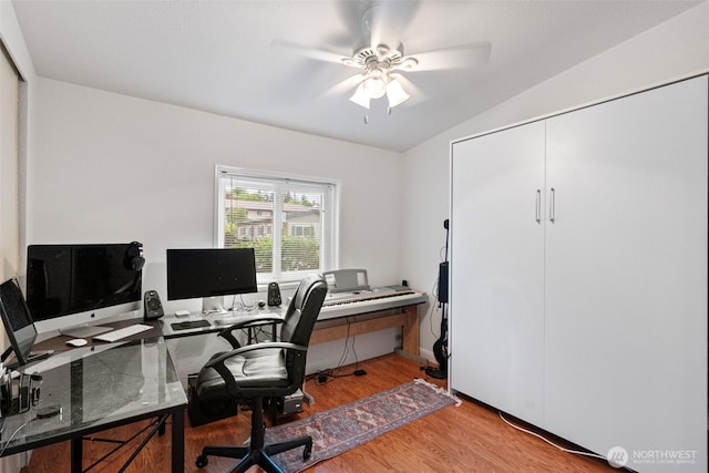 office featuring ceiling fan, lofted ceiling, and light wood-style floors