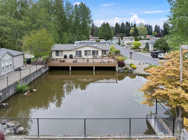 dock area featuring a water view and fence