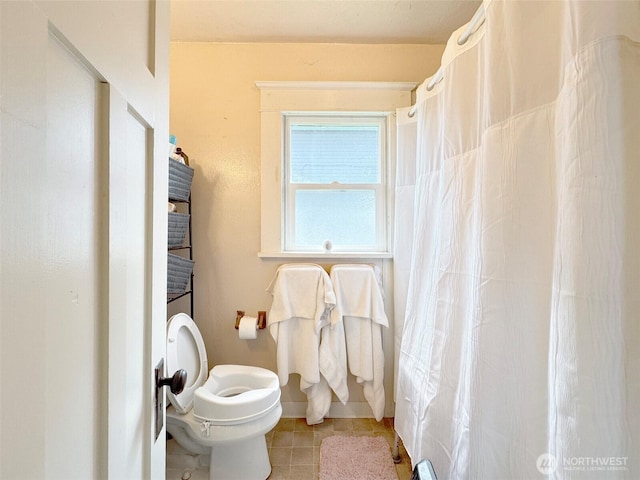 full bathroom with toilet, a shower with shower curtain, and tile patterned flooring