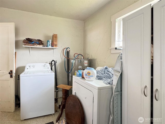 washroom with washing machine and dryer and electric water heater