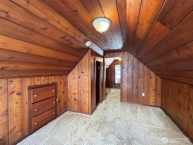 additional living space with wood ceiling, vaulted ceiling, light colored carpet, and wooden walls