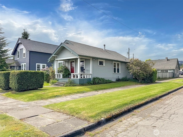 view of front of house featuring covered porch and a front lawn