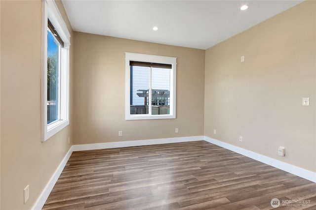 empty room featuring recessed lighting, baseboards, and wood finished floors